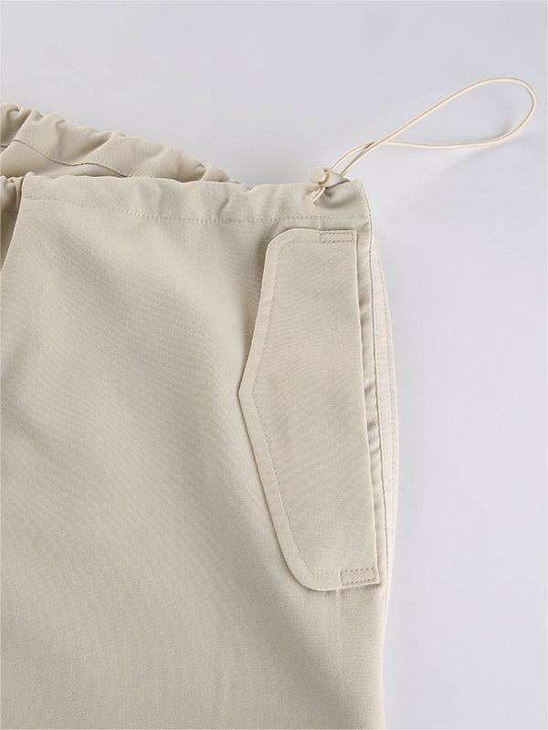 Light colored baggy parachute cargo pants with drawstring and low waist