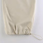 Light colored baggy parachute cargo pants with drawstring and low waist