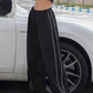 Black baggy sweatpants with piping detail