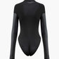 Black mock neck bodysuit with faux leather panels and long sleeves