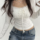 White vintage long-sleeved shirt with lace trim and binding