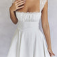 White mini dress with lace trim to tie at back