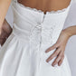 White mini dress with lace trim to tie at back