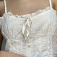 White vintage camisole with buttons and embroidered lace