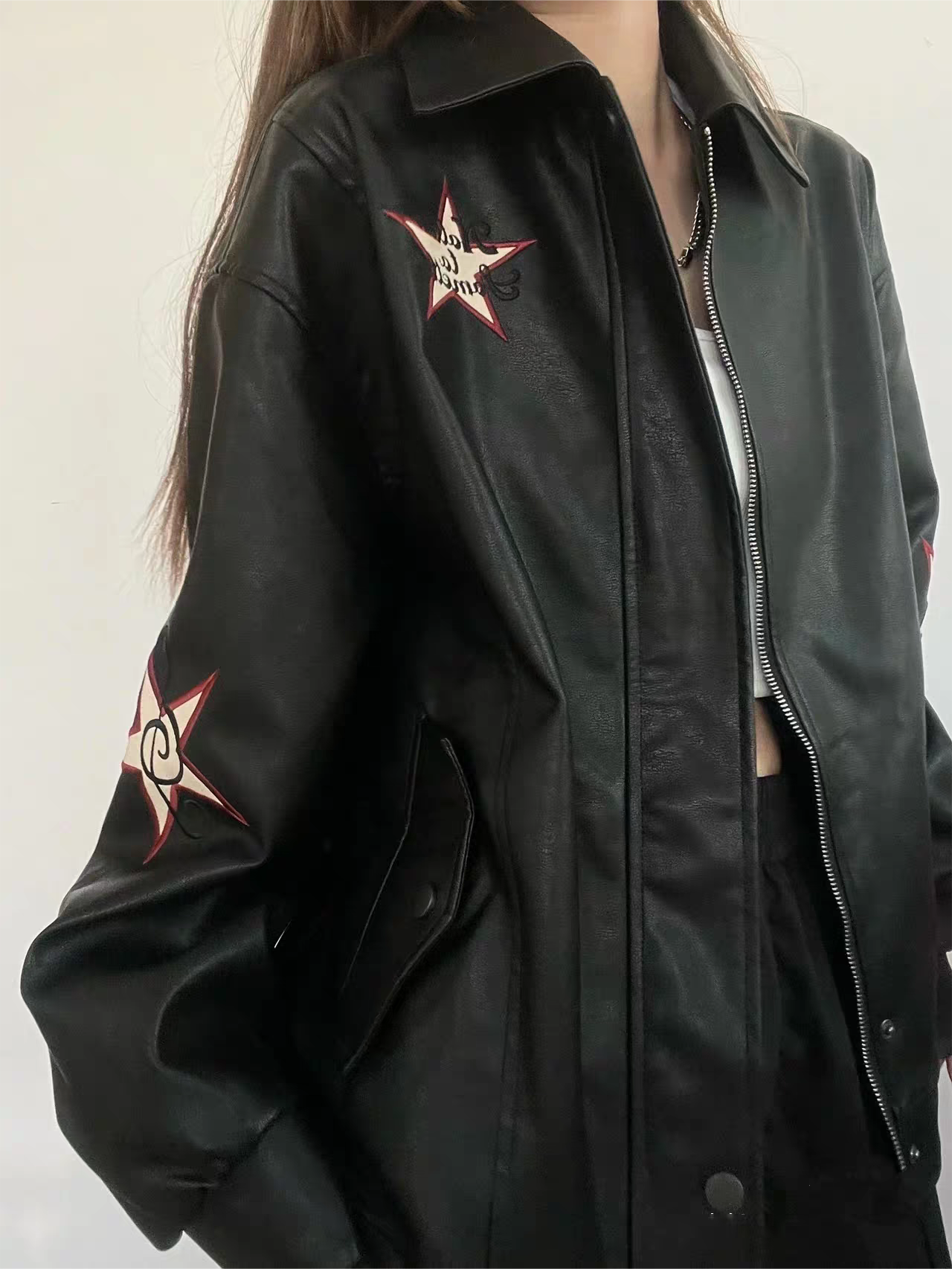 Black leather jacket with lapel collar and embroidery