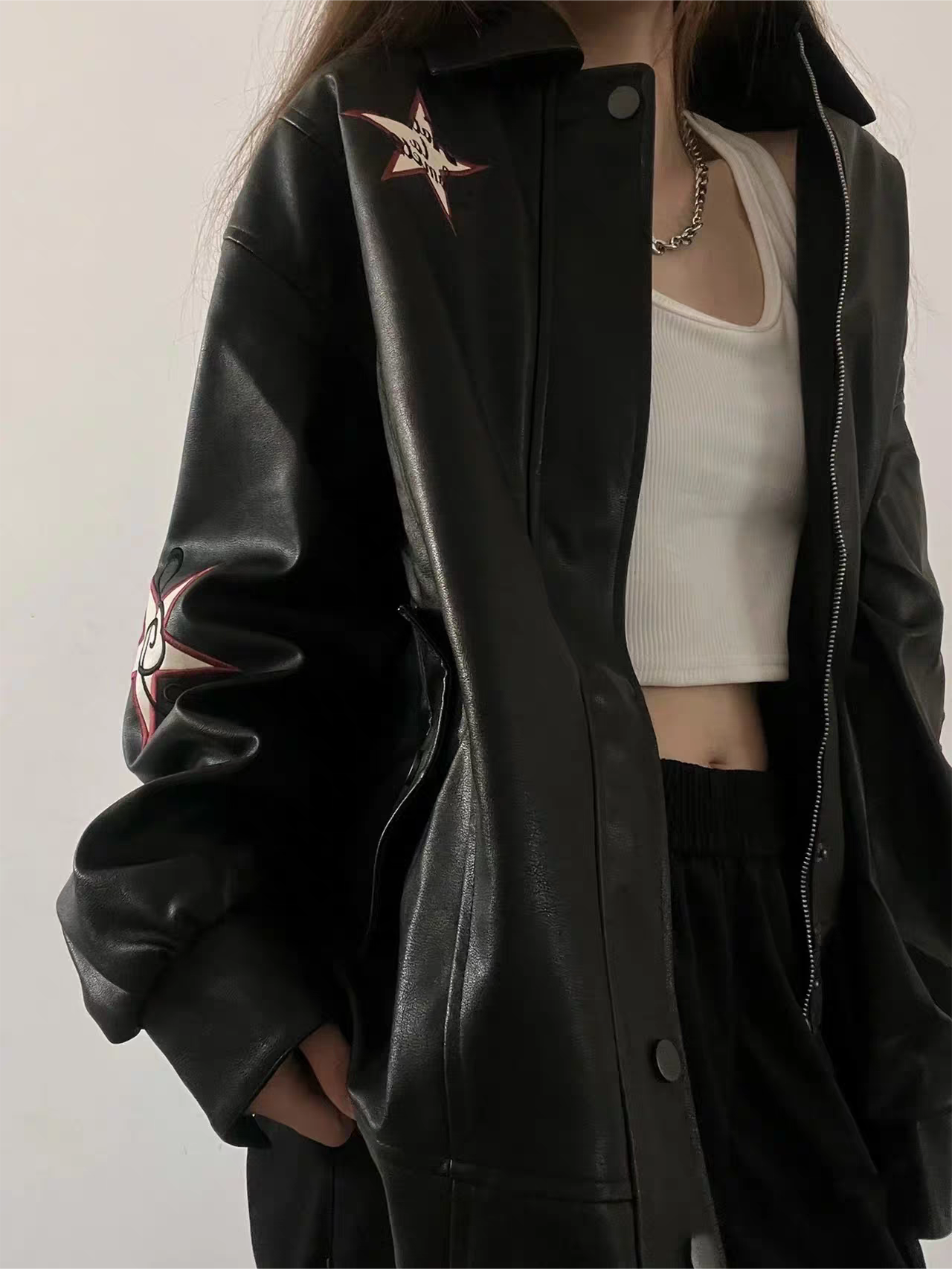 Black leather jacket with lapel collar and embroidery