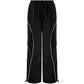 Black parachute trousers with cargo pockets and piping details