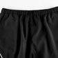Black parachute trousers with cargo pockets and piping details