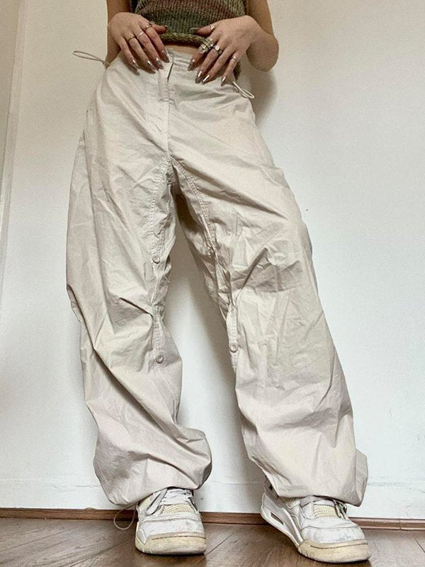 Light colored baggy parachute cargo pants with drawstring and low waist