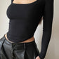 Asymmetric long sleeve crop top with scoop neckline